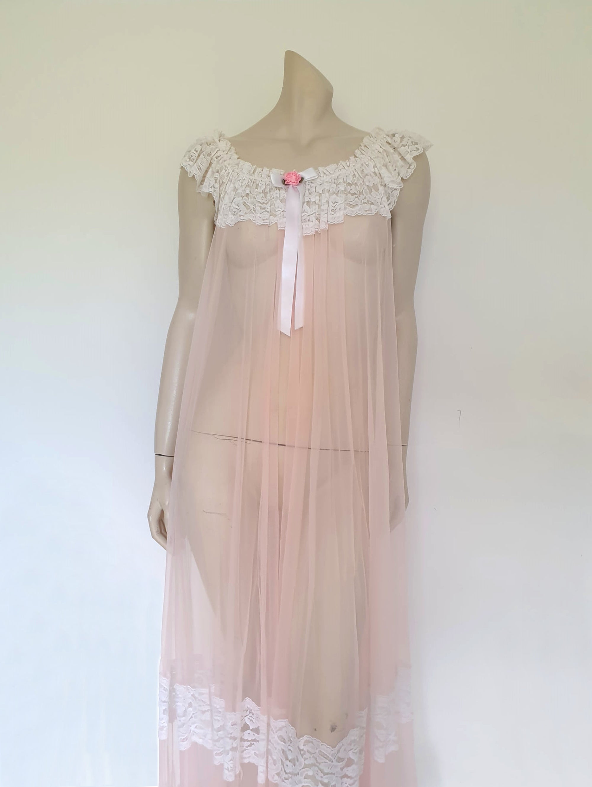 sheer vintage pale pink negligee nightgown with wide lace ruffles and short train
