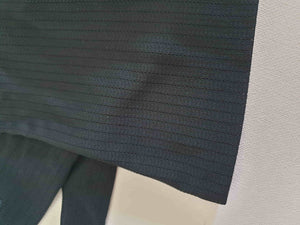 Smart black gloves for a classic dressed up look. Below wrist length stretch gloves have a striped pattern in the weave with a tiny transparent line, giving the look of a line of fine scoring. Mid weight. Fabric is nylon. No brand tag - 1960s. Large.