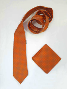 Burnt orange tie and pocket square set for a pop of colour. 
Brocade set - The fabric is woven to show a matt background and shiny medallion designs. 100% polyester. Brand is Vogue of Sydney - 1960s.