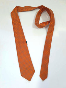 Burnt orange tie and pocket square set for a pop of colour. 
Brocade set - The fabric is woven to show a matt background and shiny medallion designs. 100% polyester. Brand is Vogue of Sydney - 1960s.