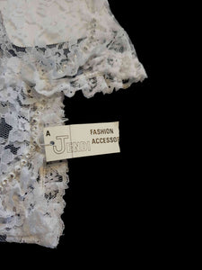 New old stock - beautiful lace bridal gloves with diamante trim, unsold stock from a former 1980s bridal boutique. White lace gloves are below-wrist length and have a shaped opening trimmed with more lace and a line of diamantes. 100% nylon. Made in Hong Kong for Jendi - 1980s.