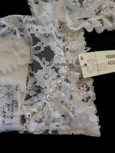 New old stock - beautiful lace bridal gloves with diamante trim, unsold stock from a former 1980s bridal boutique. White lace gloves are below-wrist length and have a shaped opening trimmed with more lace and a line of diamantes. 100% nylon. Made in Hong Kong for Jendi - 1980s.