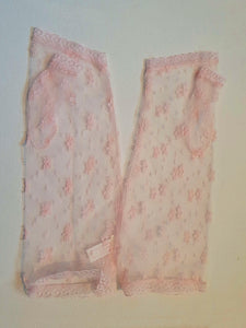New old stock - Dainty lace mitts for a special occasion. Pale pink lace mitts or fingerless gloves are mid-forearm length. Trimmed with narrow lace at the edges. 100% nylon. Made in Hong Kong. No brand label. From a former 1980s bridal boutique. Mint condition - brand new and never used.