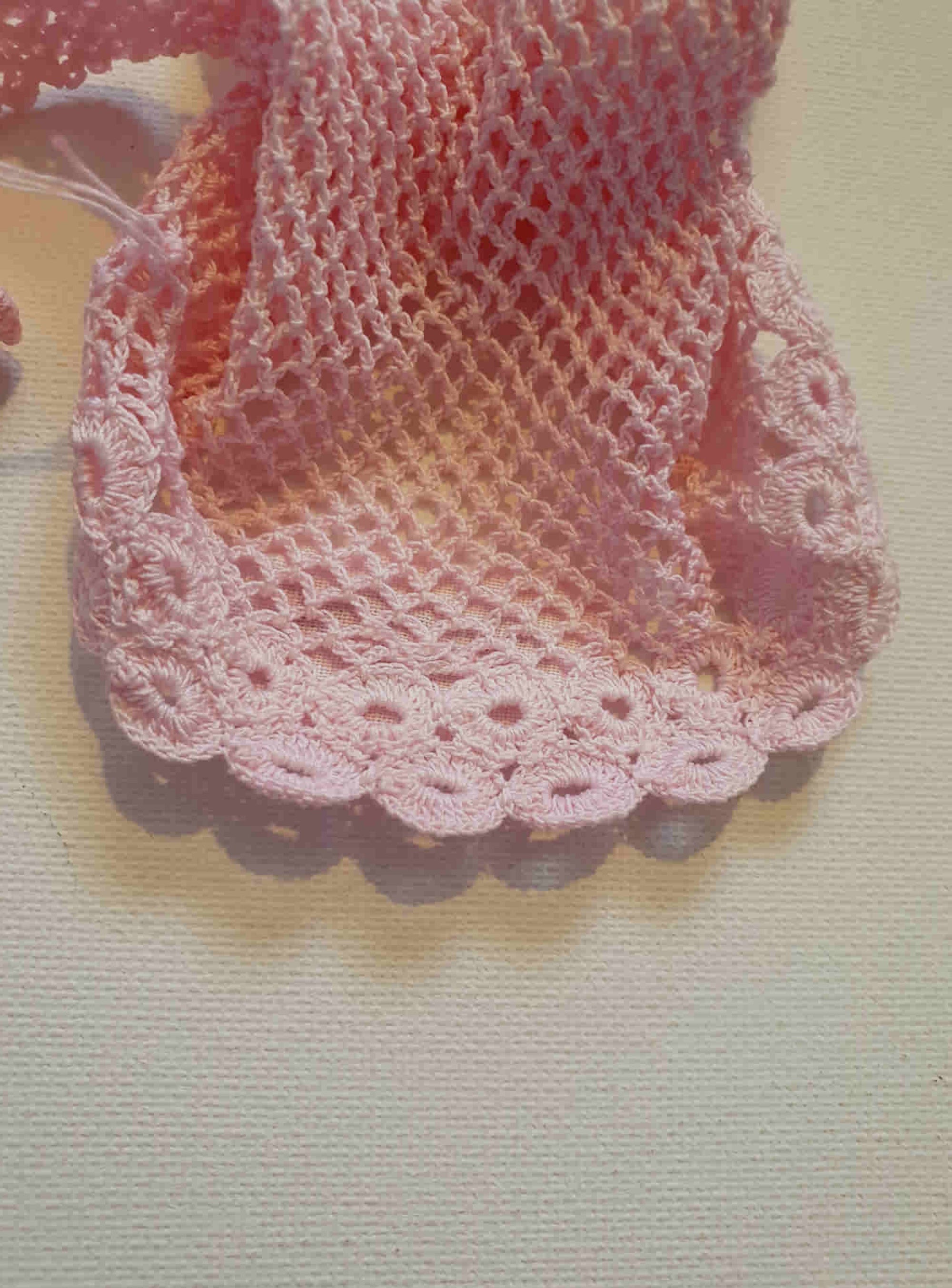 New Old Stock - Pink fingerless gloves or mitts crocheted in cotton. The top is open for four fingers, not separate finger sections apart from the thumb. Made in China. From a former bridal store operating in the 1980s.