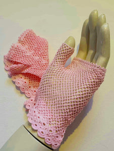 New Old Stock - Pink fingerless gloves or mitts crocheted in cotton. The top is open for four fingers, not separate finger sections apart from the thumb. Made in China. From a former bridal store operating in the 1980s.