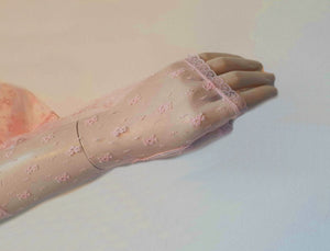 New old stock - Dainty lace mitts for a special occasion. Pale pink lace mitts or fingerless gloves are mid-forearm length. Trimmed with narrow lace at the edges. 100% nylon. Made in Hong Kong. No brand label. From a former 1980s bridal boutique. Mint condition - brand new and never used.