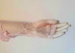 New old stock - Dainty lace mitts for a special occasion. Pale pink lace mitts or fingerless gloves are mid-forearm length. Trimmed with narrow lace at the edges. 100% nylon. Made in Hong Kong. No brand label. From a former 1980s bridal boutique. Mint condition - brand new and never used.