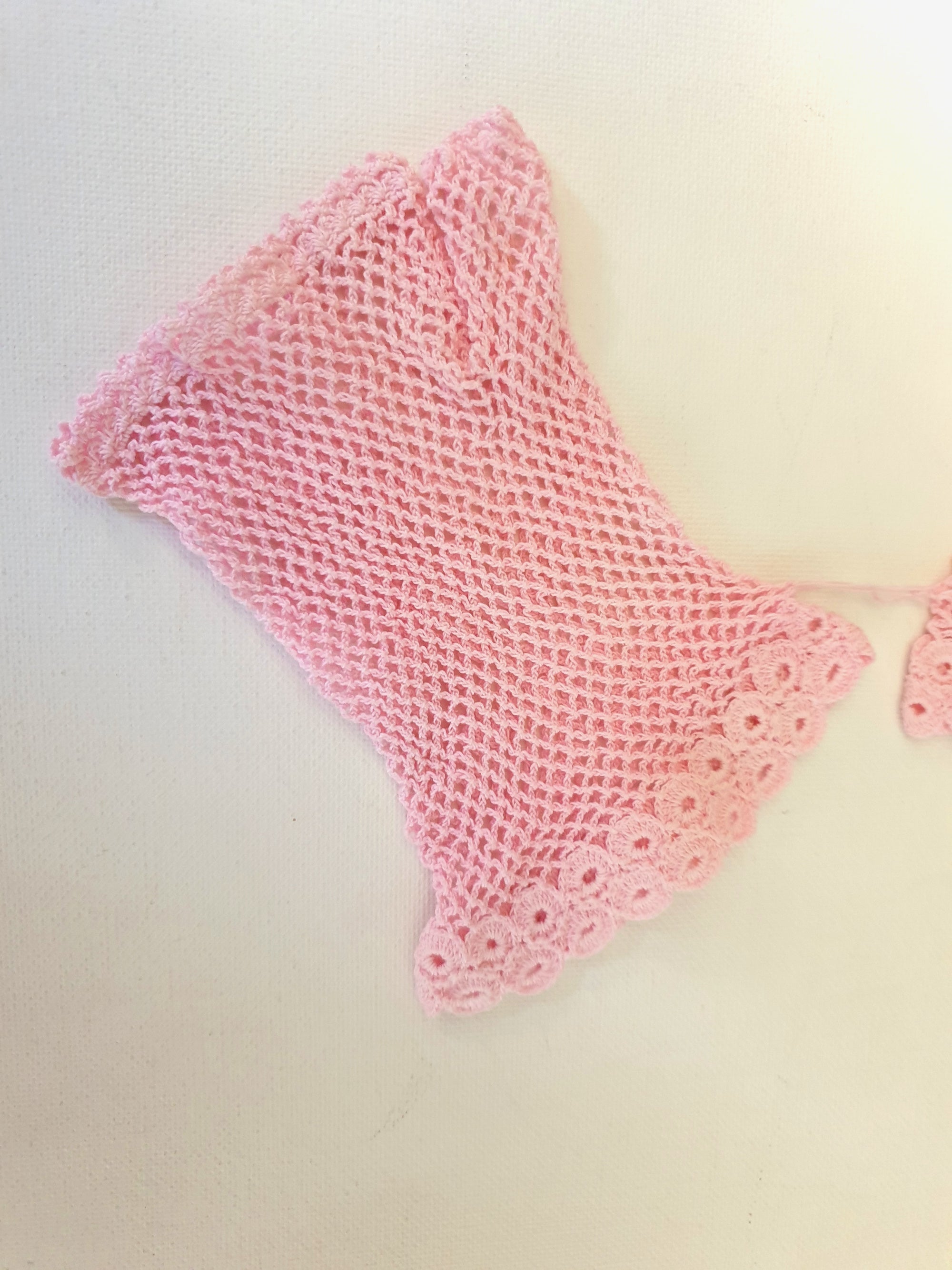 New Old Stock - Pink fingerless gloves or mitts crocheted in cotton. The top is open for four fingers, not separate finger sections apart from the thumb. Made in China. From a former bridal store operating in the 1980s.