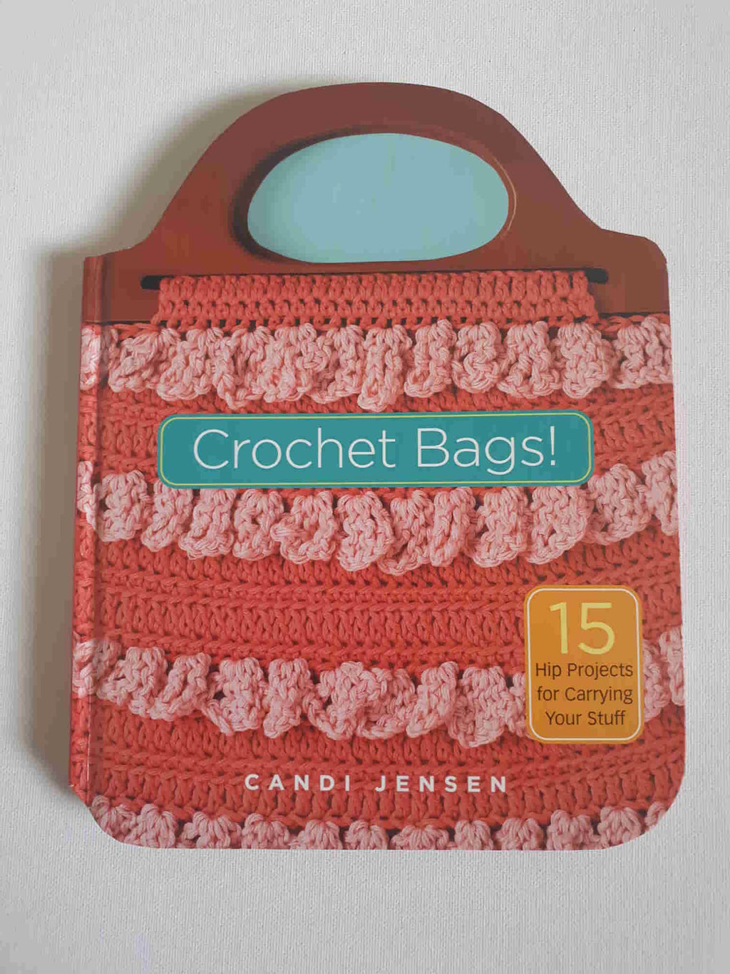 Great little book of patterns for vintage style crocheted bags by designer Candi Jensen. Totes, hobo bags, coin purses and a waterproof beach bag crocheted from recycled shopping bags. Some designs use granny squares, some are embellished with feathers and beads. Hard cover book. 15 designs and 111 pages. Published 2005 by Storey Books, USA.
