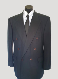 Very dark green (can appear black) double-breasted jacket has peak lapels and no rear vent. Six button front stance and three button sleeve trim. Two front flapped pockets, breast pocket and three interior pockets. Fully lined. Fabric is 70% wool, 20% nylon and 10% cashmere. 1990s, 42M