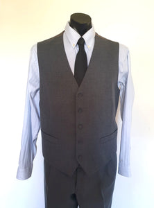 The suit jacket has notched lapels, flapped pockets, breast pocket, two button closure, three button sleeve trim and three interior pockets. It has two rear vents.
The vest has two pockets and five button closure. There is no belt for rear adjustment.
The trousers have straight legs, two front pleats at the waist, two diagonal side pockets, coin pocket and two buttoning rear pockets. 
The fabric is 80% wool, 20% polyester. Made by the iconic Fletcher Jones Australia. Conveniently dated 1-5-1990. Size 117R.