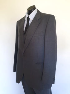 The suit jacket has notched lapels, flapped pockets, breast pocket, two button closure, three button sleeve trim and three interior pockets. It has two rear vents.
The vest has two pockets and five button closure. There is no belt for rear adjustment.
The trousers have straight legs, two front pleats at the waist, two diagonal side pockets, coin pocket and two buttoning rear pockets. 
The fabric is 80% wool, 20% polyester. Made by the iconic Fletcher Jones Australia. Conveniently dated 1-5-1990. Size 117R.