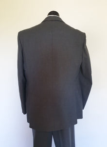 The suit jacket has notched lapels, flapped pockets, breast pocket, two button closure, three button sleeve trim and three interior pockets. It has two rear vents.
The vest has two pockets and five button closure. There is no belt for rear adjustment.
The trousers have straight legs, two front pleats at the waist, two diagonal side pockets, coin pocket and two buttoning rear pockets. 
The fabric is 80% wool, 20% polyester. Made by the iconic Fletcher Jones Australia. Conveniently dated 1-5-1990. Size 117R.