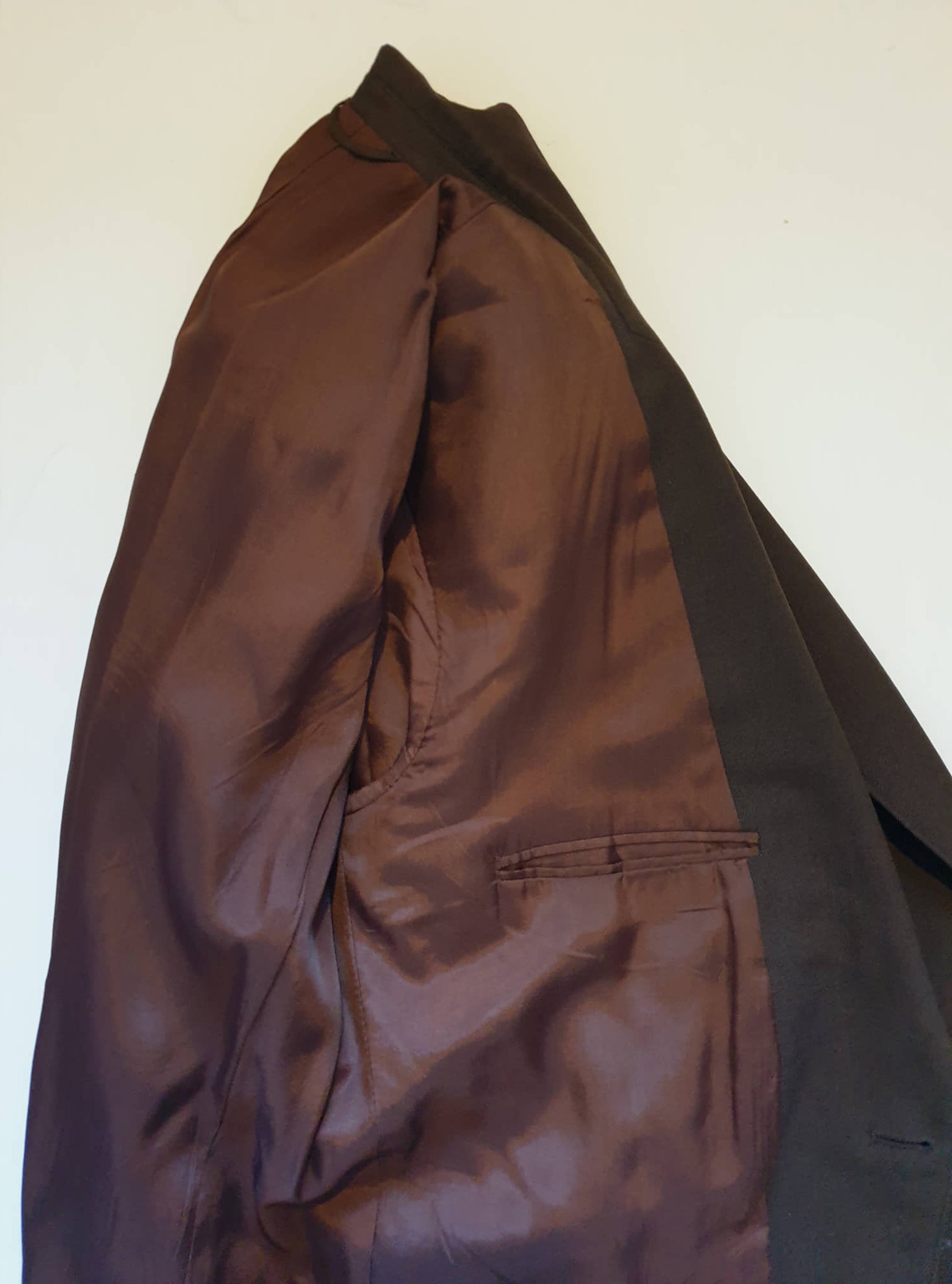 1970s blazer is chocolate brown and has notched lapels. It sports pewter coloured metal buttons featuring a heraldic crest. Three patch pockets at the front, one has a coin pocket. Three interior pockets. One button sleeve trim and two button closure. Rear vent. Fabric is 55% polyester, 45% wool. Lining appears to be rayon. Brand is the well known Australian tailoring company Stafford Ellinson - 1970s. 46RXL