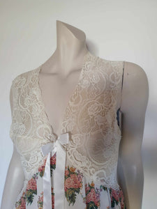 Beautiful and elegant nightgown. Long nightgown has a pink and green floral print on a cream ground. The fitted front bodice is cream stretch lace. There's also panel of lace at centre back. Trimmed with a satin bow and long ribbons beneath the bust. There are no labels, but the fabric is polyester georgette. 1980s. Bust 92 cm (36")