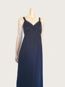 Black maxi slip originally worn under an evening gown or funky maxi dress. You can use it as a slip, nightgown or dress. It has stretch lace straps and bodice trim. Straps are no adjustable. Fabric is "no cling" nylon. Brand is Osti - 1970s. Medium