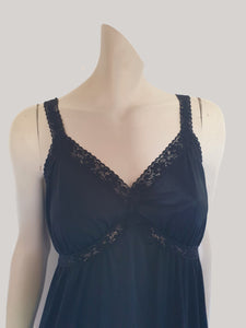 Black maxi slip originally worn under an evening gown or funky maxi dress. You can use it as a slip, nightgown or dress. It has stretch lace straps and bodice trim. Straps are no adjustable. Fabric is "no cling" nylon. Brand is Osti - 1970s. Medium