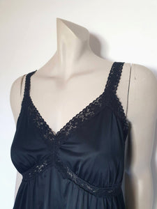 Black maxi slip originally worn under an evening gown or funky maxi dress. You can use it as a slip, nightgown or dress. It has stretch lace straps and bodice trim. Straps are no adjustable. Fabric is "no cling" nylon. Brand is Osti - 1970s. Medium