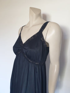 Black maxi slip originally worn under an evening gown or funky maxi dress. You can use it as a slip, nightgown or dress. It has stretch lace straps and bodice trim. Straps are no adjustable. Fabric is "no cling" nylon. Brand is Osti - 1970s. Medium