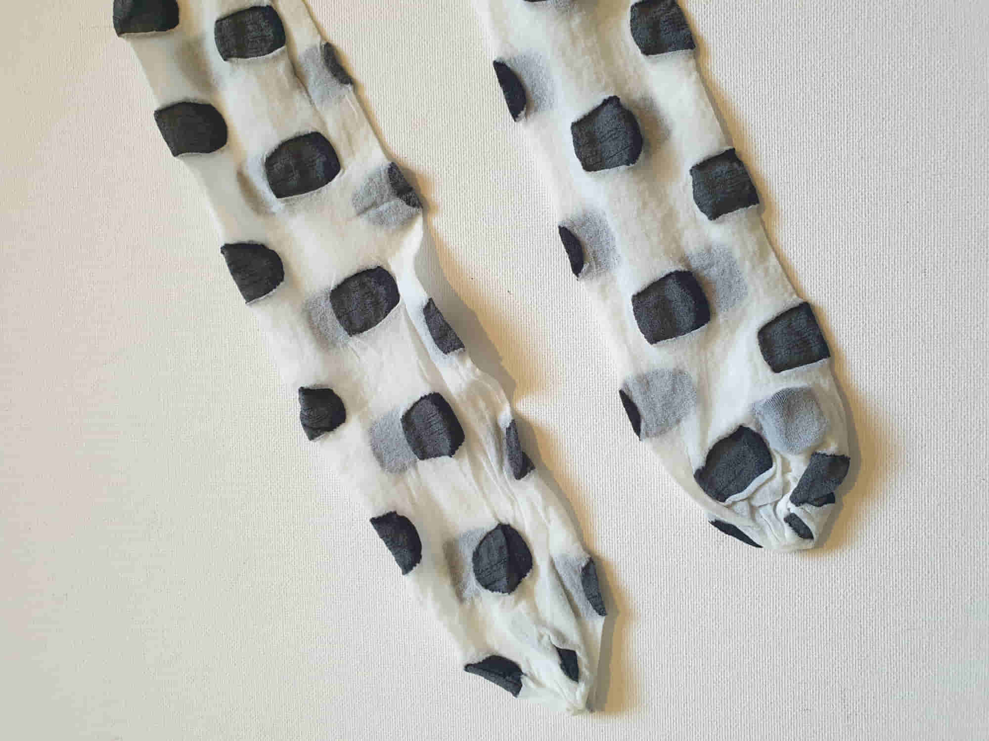 Make a statement with these Superblob tights by luxury hosiery brand Jonathan Aston. Sheer white pantyhose/tights with very large black polka dots. 100% nylon. Made in England - 1980s. Fits 163-180 cm/59-75 kg (5'4"-5'9"/130-165 lbs.) New old stock, in the original packaging, unworn.