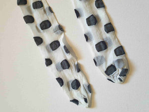 Make a statement with these Superblob tights by luxury hosiery brand Jonathan Aston. Sheer white pantyhose/tights with very large black polka dots. 100% nylon. Made in England - 1980s. Fits 163-180 cm/59-75 kg (5'4"-5'9"/130-165 lbs.) New old stock, in the original packaging, unworn.