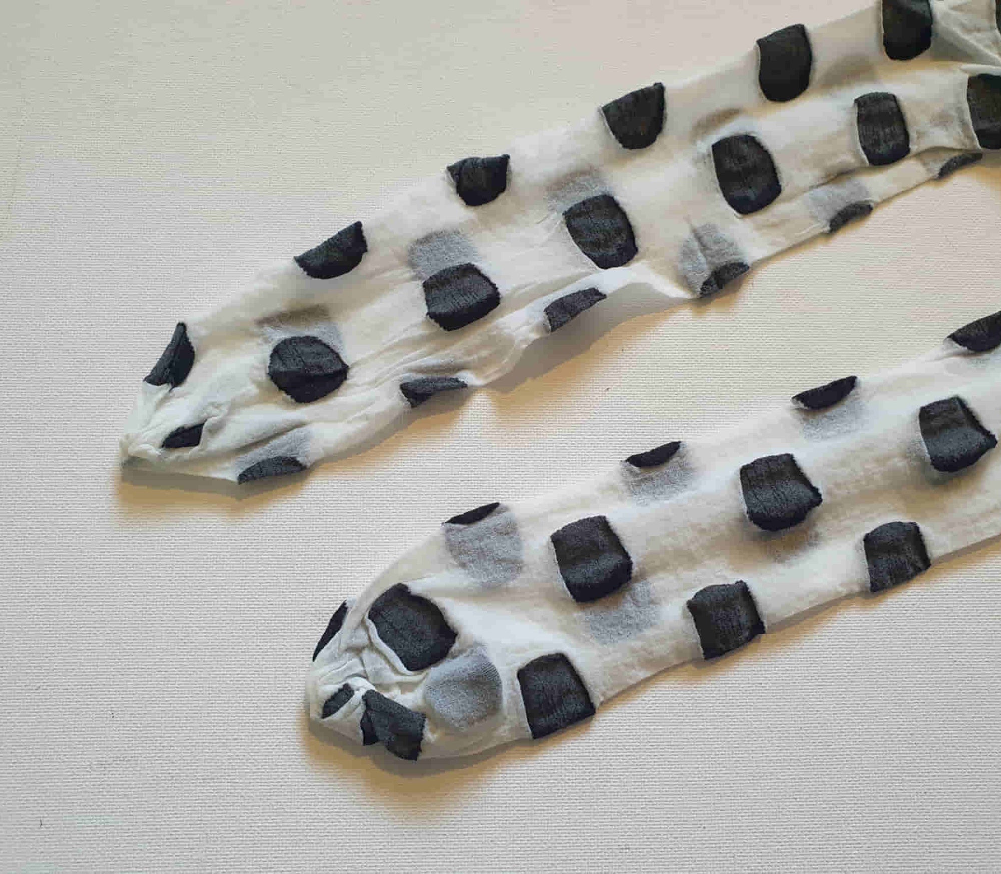 Make a statement with these Superblob tights by luxury hosiery brand Jonathan Aston. Sheer white pantyhose/tights with very large black polka dots. 100% nylon. Made in England - 1980s. Fits 163-180 cm/59-75 kg (5'4"-5'9"/130-165 lbs.) New old stock, in the original packaging, unworn.