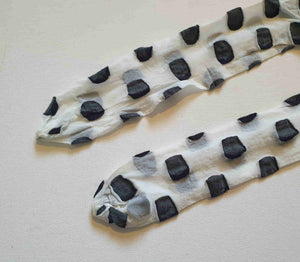 Make a statement with these Superblob tights by luxury hosiery brand Jonathan Aston. Sheer white pantyhose/tights with very large black polka dots. 100% nylon. Made in England - 1980s. Fits 163-180 cm/59-75 kg (5'4"-5'9"/130-165 lbs.) New old stock, in the original packaging, unworn.