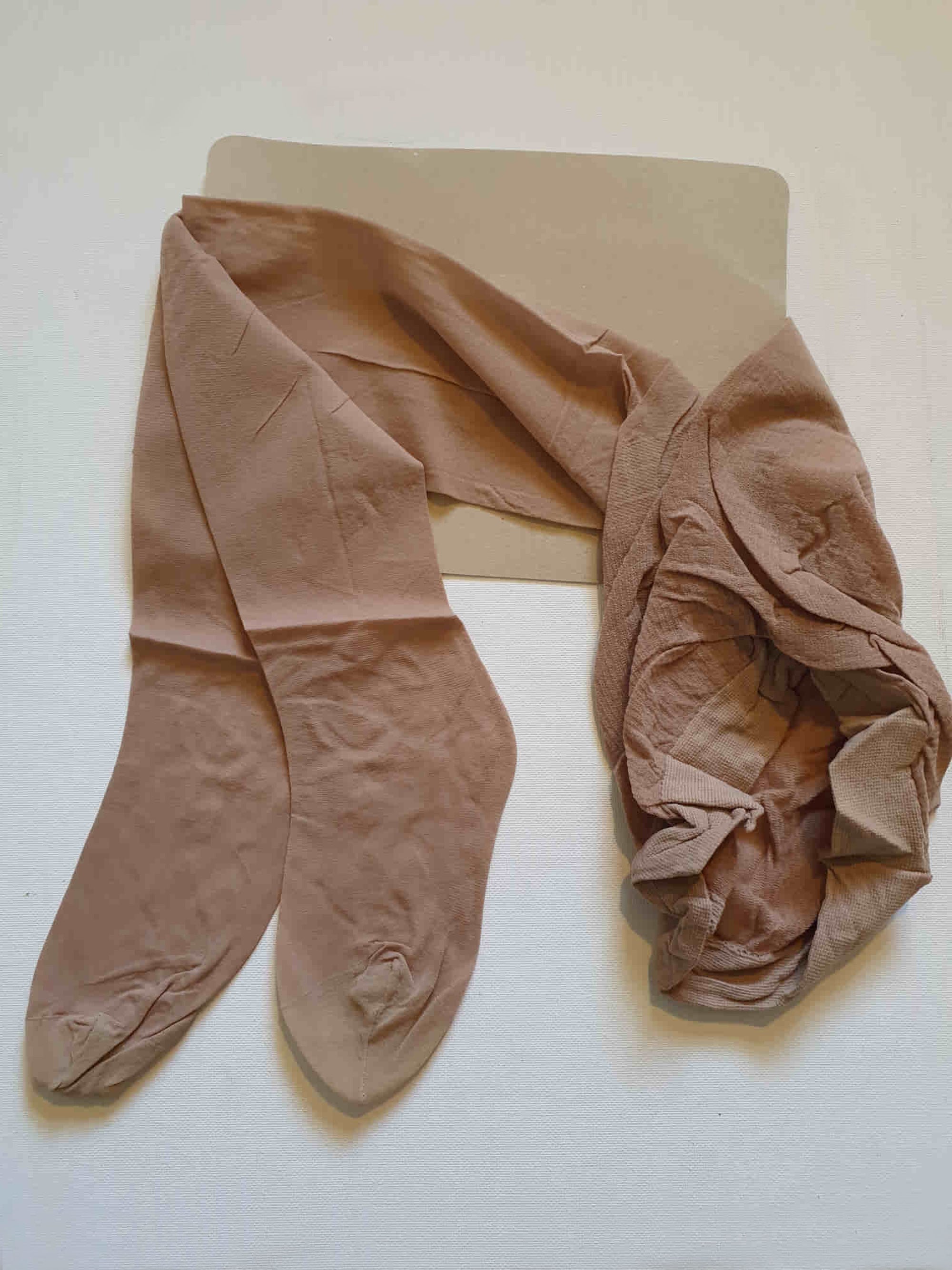 New old stock vintage pantyhose. All over sheer support - relief for active legs. "From waist to toe - gentle support follows your every contour." Cotton gusset and reinforced toe. Colour is Almond - a light beige, skin tone. Brand is Julia's by Kayser - 1980s or early 1990s. Size - Mids