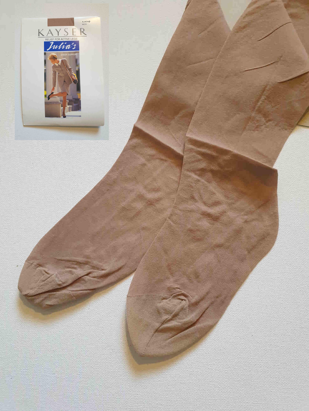 New old stock vintage pantyhose. All over sheer support - relief for active legs. "From waist to toe - gentle support follows your every contour." Cotton gusset and reinforced toe. Colour is Almond - a light beige, skin tone. Brand is Julia's by Kayser - 1980s or early 1990s. Size - Mids