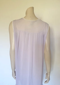 Pretty pale mauve crepe nightgown and robe set has a lace yoke tying at the neck with a ribbon on both the gown and robe. Pleas note: the colour is lighter than it appears in the photos. Above-knee length set has a high V neck and lace and pink ribbon trim at the yoke and sleeves. Hemline is also lace trimmed.  The robe has short sleeves, the gown is sleeveless. Fabric is nylon crepe. Brand is Irene - 1970s. Medium.