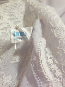 Pretty pale mauve crepe nightgown and robe set has a lace yoke tying at the neck with a ribbon on both the gown and robe. Pleas note: the colour is lighter than it appears in the photos. Above-knee length set has a high V neck and lace and pink ribbon trim at the yoke and sleeves. Hemline is also lace trimmed.  The robe has short sleeves, the gown is sleeveless. Fabric is nylon crepe. Brand is Irene - 1970s. Medium.