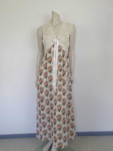 Beautiful and elegant nightgown. Long nightgown has a pink and green floral print on a cream ground. The fitted front bodice is cream stretch lace. There's also panel of lace at centre back. Trimmed with a satin bow and long ribbons beneath the bust. There are no labels, but the fabric is polyester georgette. 1980s. Bust 92 cm (36")