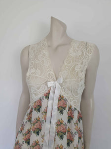 Beautiful and elegant nightgown. Long nightgown has a pink and green floral print on a cream ground. The fitted front bodice is cream stretch lace. There's also panel of lace at centre back. Trimmed with a satin bow and long ribbons beneath the bust. There are no labels, but the fabric is polyester georgette. 1980s. Bust 92 cm (36")