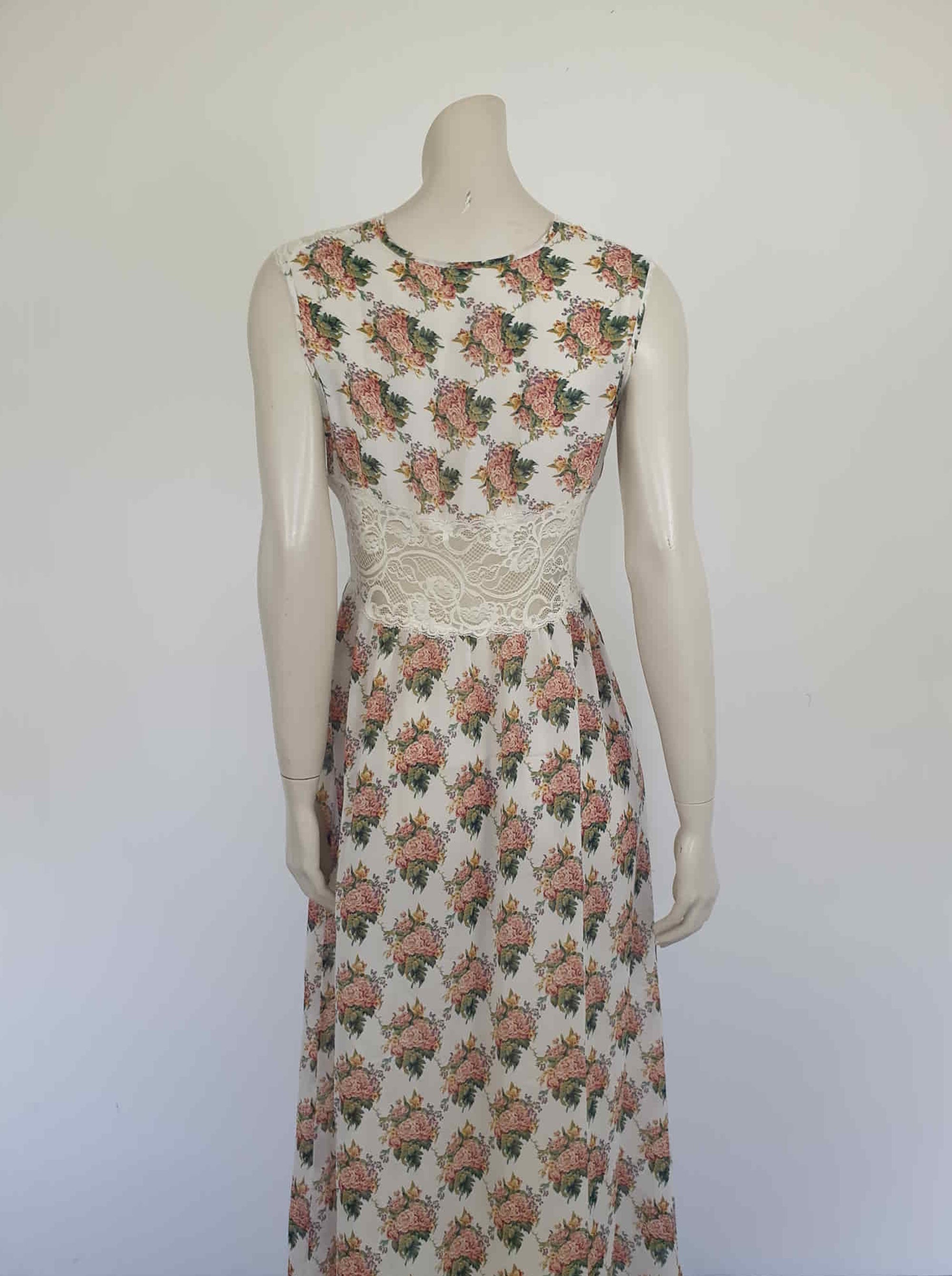 Beautiful and elegant nightgown. Long nightgown has a pink and green floral print on a cream ground. The fitted front bodice is cream stretch lace. There's also panel of lace at centre back. Trimmed with a satin bow and long ribbons beneath the bust. There are no labels, but the fabric is polyester georgette. 1980s. Bust 92 cm (36")