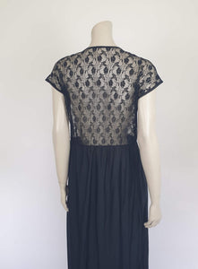 Black lace top robe style negligee is full length and has a dropped shoulder forming a cap sleeve effect. I have replaced the missing button at the waist with a silver vintage button. The waist is on elastic. Fabric is nylon. Made in South Africa for the party plan label "It's A Pleasure" - 1980s. Small.