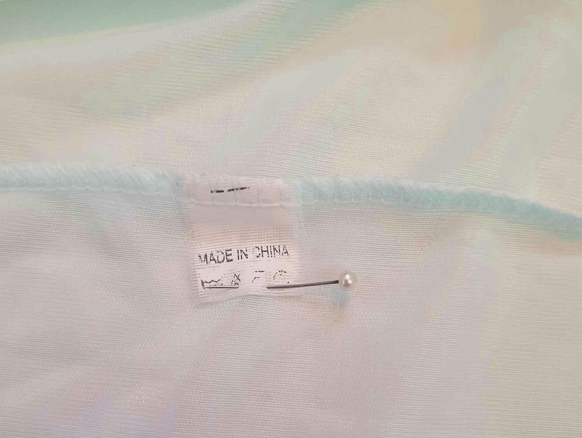 Pretty above knee length blue nightgown has ruffled straps and armholes, lace bodice and front bow. Ruffle at the hemline. Fabric is nylon. No brand label. Made in China. 1980s-1990s.