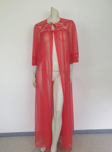 Glamourous  robe or peignoir is very sheer and has full three-quarter length sleeves trimmed with wide lace. The same lace is inserted across the front as a yoke. Closes with a double tie at the neck. Fabric is nylon. Made in the USA for Sears - 1960s. Medium
