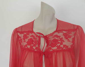 Glamourous  robe or peignoir is very sheer and has full three-quarter length sleeves trimmed with wide lace. The same lace is inserted across the front as a yoke. Closes with a double tie at the neck. Fabric is nylon. Made in the USA for Sears - 1960s. Medium
