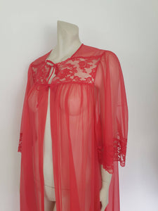 Glamourous  robe or peignoir is very sheer and has full three-quarter length sleeves trimmed with wide lace. The same lace is inserted across the front as a yoke. Closes with a double tie at the neck. Fabric is nylon. Made in the USA for Sears - 1960s. Medium