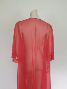 Glamourous  robe or peignoir is very sheer and has full three-quarter length sleeves trimmed with wide lace. The same lace is inserted across the front as a yoke. Closes with a double tie at the neck. Fabric is nylon. Made in the USA for Sears - 1960s. Medium