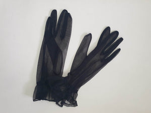 New old stock - classy and sophisticated sheer black gloves with a ruffle at the wrist. Fabric is nylon. No tags. Medium.