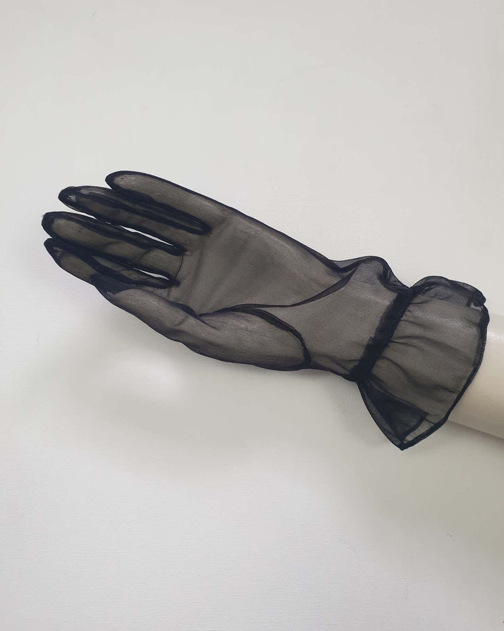 New old stock - classy and sophisticated sheer black gloves with a ruffle at the wrist. Fabric is nylon. No tags. Medium.