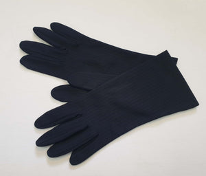 Smart black gloves for a classic dressed up look. Below wrist length stretch gloves have a striped pattern in the weave with a tiny transparent line, giving the look of a line of fine scoring. Mid weight. Fabric is nylon. No brand tag - 1960s. Large.