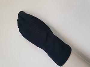 Smart black gloves for a classic dressed up look. Below wrist length stretch gloves have a striped pattern in the weave with a tiny transparent line, giving the look of a line of fine scoring. Mid weight. Fabric is nylon. No brand tag - 1960s. Large.