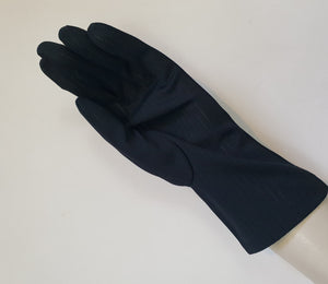 Smart black gloves for a classic dressed up look. Below wrist length stretch gloves have a striped pattern in the weave with a tiny transparent line, giving the look of a line of fine scoring. Mid weight. Fabric is nylon. No brand tag - 1960s. Large.