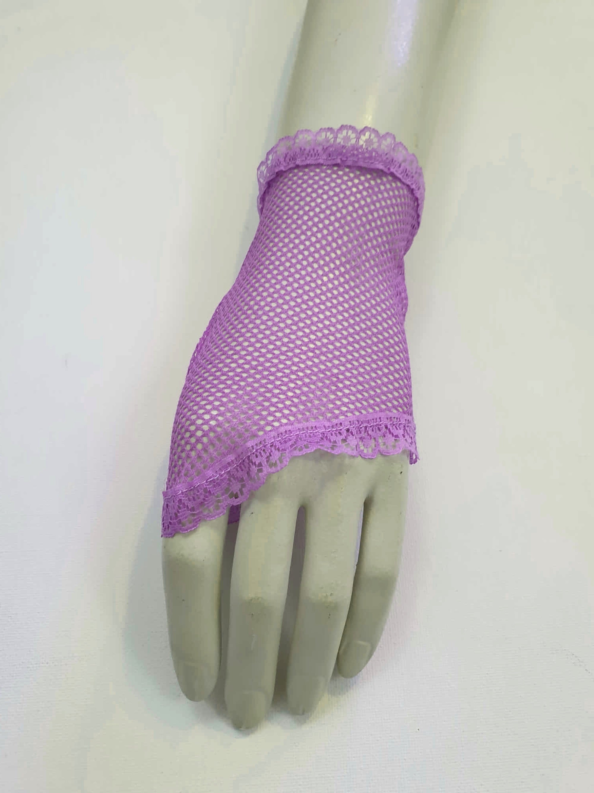 New old stock vintage purple fingerless gloves or mitts. Mitts are wrist length and are finished at all edges with lace trim. Colour is light purple - mauve - lavender. Fabric is nylon mesh. Made in Hong Kong. Unsold stock from a former 1980s bridal boutique. Small to Medium