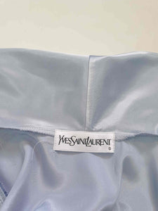 Beautiful blue satin robe with two patch pockets. Sleeves and pockets are trimmed with wide blue and white lace. Shawl collar and separate tie through carriers at the waist. Shoulder pads. Fabric is polyester satin. Made under licence in Australia for a famous French designer, see label - 1980s.