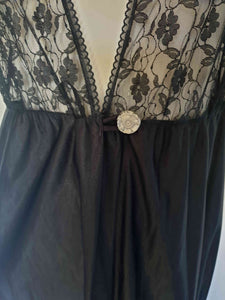 Black lace top robe style negligee is full length and has a dropped shoulder forming a cap sleeve effect. I have replaced the missing button at the waist with a silver vintage button. The waist is on elastic. Fabric is nylon. Made in South Africa for the party plan label "It's A Pleasure" - 1980s. Small.