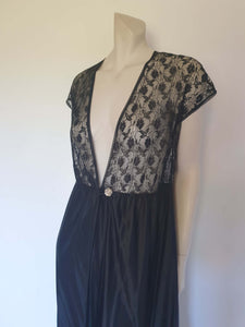 Black lace top robe style negligee is full length and has a dropped shoulder forming a cap sleeve effect. I have replaced the missing button at the waist with a silver vintage button. The waist is on elastic. Fabric is nylon. Made in South Africa for the party plan label "It's A Pleasure" - 1980s. Small.