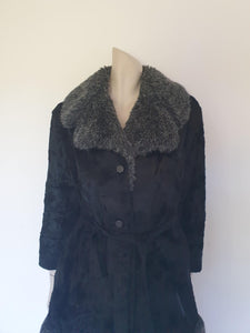 Fabulous little faux fur mini coat, just the thing that Twiggy might have worn. Black synthetic fur coat has a large fluffy grey collar and hem band. It has two side seam pockets and a matching tie running through carriers at the waist. Bound buttonholes. I have added three vintage metal buttons as the originals were missing. Fully lined with rayon or acetate. No labels at all - 1960s. Small.